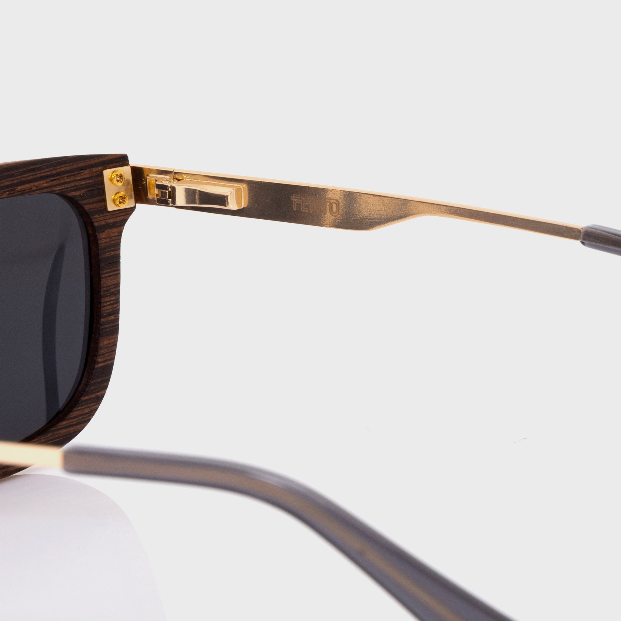 Specta Sunglasses – wengue wood frame with gold accents and sleek grey lenses.